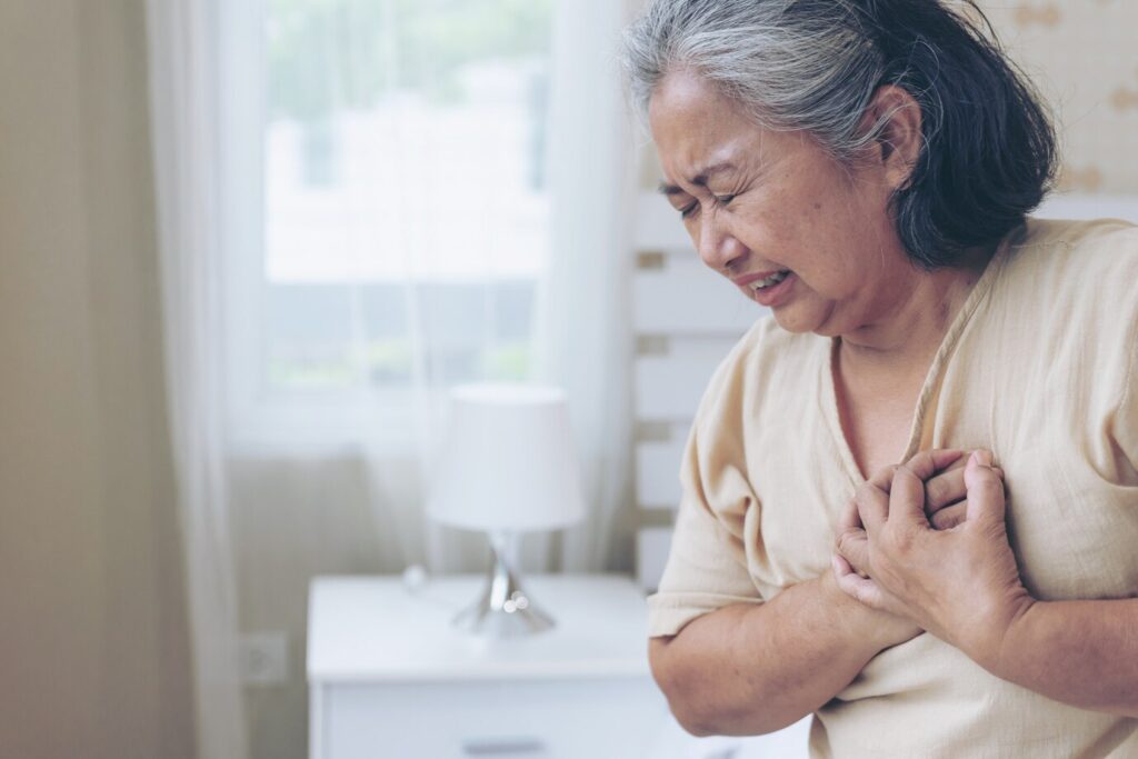 senior female asian suffering from bad pain his chest heart attack home senior heart disease 1150 21732 - Ileria CPR Feedback training technology