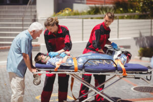 Paramedics transporting a patient after initiating CPR