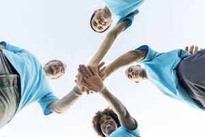 group happy diverse volunteers - Ileria CPR Feedback training technology
