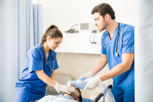team male female doctors using ambu bag ventilation unconscious patient - Ileria CPR Feedback training technology